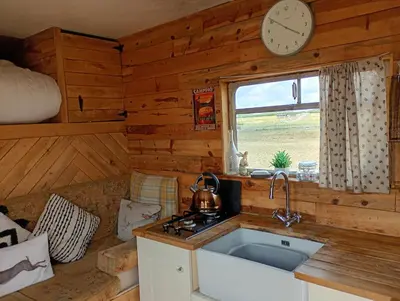 a kitchen with a sink and a clock on the wall at The Box in Moffat
