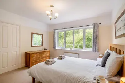a bedroom with a large white bed and a window at 3 Bed in Ravenglass oc-e32106 in Ravenglass