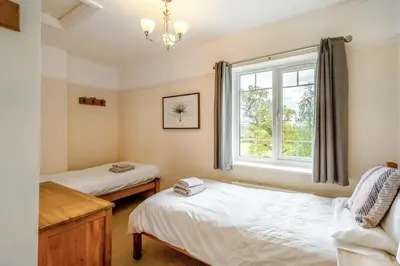 a bedroom with two beds and a window at 3 Bed in Ravenglass oc-e32106 in Ravenglass