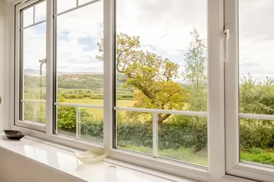 an open window with a view of a tree at 3 Bed in Ravenglass oc-e32106 in Ravenglass