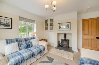 a living room with a couch and a fireplace at 3 Bed in Ravenglass oc-e32106 in Ravenglass