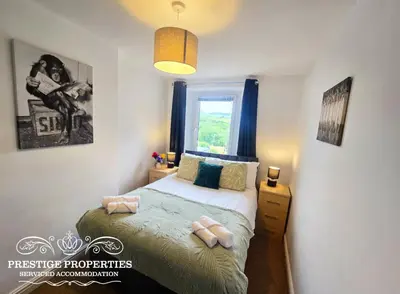 a bedroom with a bed and a window at Moon Cottage By Prestige Properties SA in Egremont