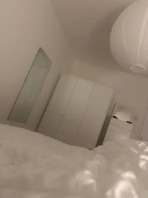 a bedroom with white walls and a white ceiling at Home stay in Moffat