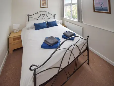 a bedroom with a bed with two towels on it at Station House in St Bees