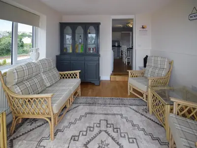 a living room with two chairs and a couch at Station House in St Bees