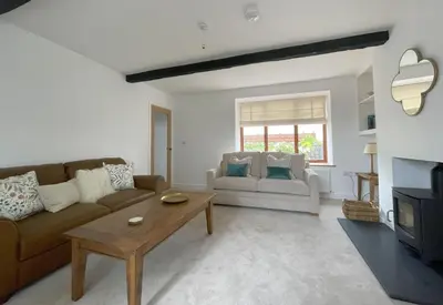 a living room with a couch and a coffee table at Mill House in Braithwaite