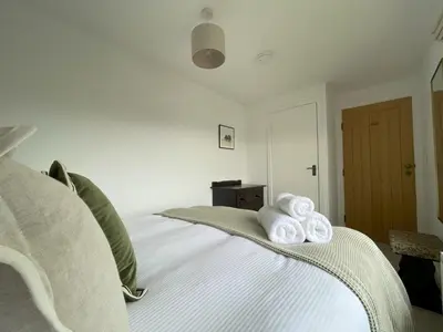 a bedroom with a bed with towels on it at Mill House in Braithwaite