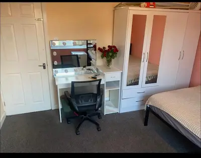 a bedroom with a desk with a computer and a chair at Coven in Moffat