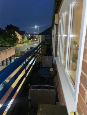 a balcony with chairs and a table on a building at Coven in Moffat