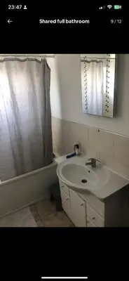 a bathroom with a sink and a tub and a mirror at Coven in Moffat