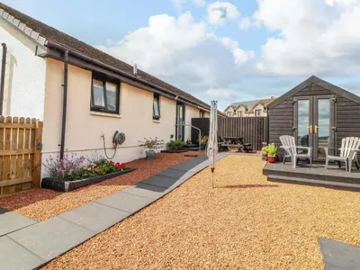 a backyard of a house with a patio at The Paddock in Kirkcowan