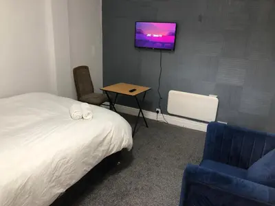 a bedroom with a bed and a tv on a wall at Marina Regency in Moffat