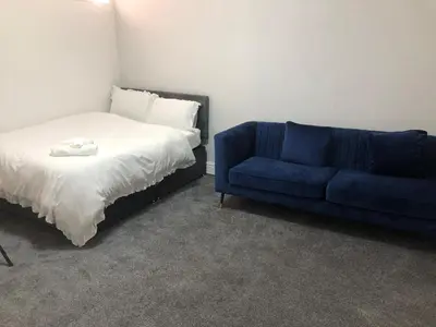 a bedroom with a bed and a blue couch at Marina Regency in Moffat
