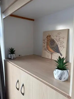 a cabinet with two potted plants on top of it at Modern 3BR House Near Manchester-Parking Included in Moffat