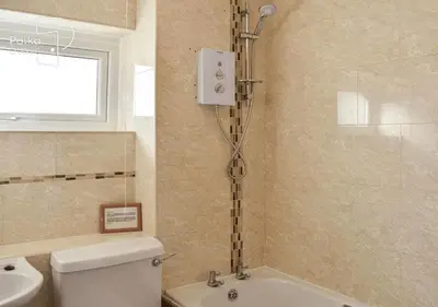 a bathroom with a shower and a toilet and a sink at Crag Barn Cottage Lake District by PolkaStays in Penrith