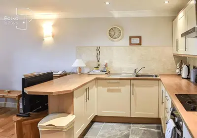 a kitchen with a sink and a counter top at Crag Barn Cottage Lake District by PolkaStays in Penrith