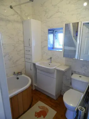 a white bathroom with a sink and a toilet at 2 Bedroom & 2Bathrooms in Lancaster in Moffat