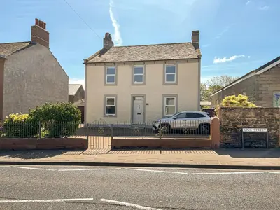 a house with a car parked in front of it at Midtown House in Aspatria