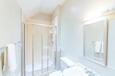 a bathroom with a shower and a sink at Penninghame Estate - Bruce Apartment in Challoch