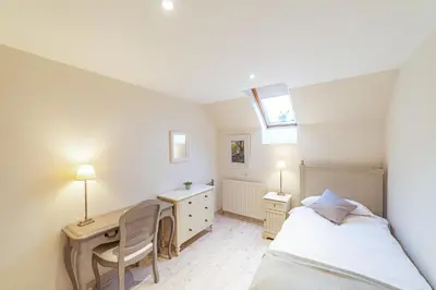 a bedroom with a desk and a bed and a desk at Penninghame Estate - Wallace Apartment in Challoch