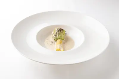 a white bowl with a piece of broccoli in it at Knockinaam Lodge in Portpatrick