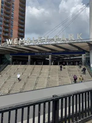 a group of people walking around a stadium at Your Base To Explore London in Moffat