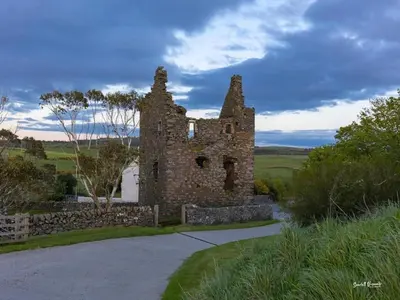 an old stone building in the middle of a road at 3 Bed in Leswalt oc-g32241 in Leswalt