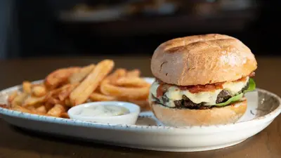 a plate with a sandwich and french fries on a table at The Briery in Workington