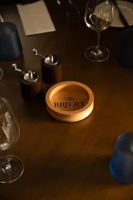 a wooden box with thelibrary written on it on a table with glasses at The Briery in Workington