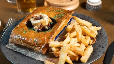a plate with a sandwich and french fries on a table at The Briery in Workington