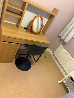 a wooden desk with a mirror and a chair at Single Room in Moffat