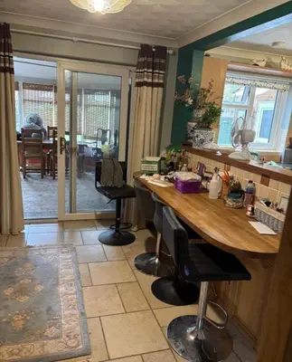 a kitchen with a large wooden table and chairs at Single Room in Moffat