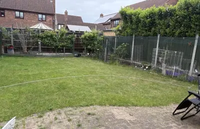 a backyard with a basketball hoop and a fence at Single Room in Moffat