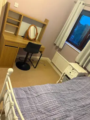 a bedroom with a desk and a chair next to a bed at Single Room in Moffat