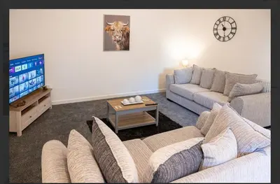 a living room with a couch and a tv at Central Mews Free Wi-Fi-Parking-Contractors in Newton Stewart