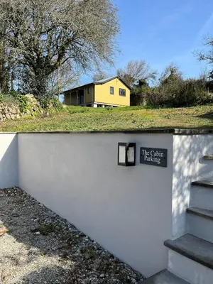 a sign on a wall next to a house at Newly built luxury cabin in Moffat