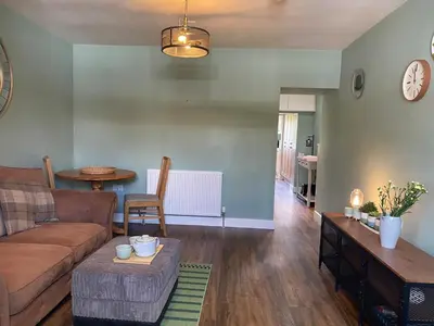 a living room with a couch and a table at Granite House in Carsphairn