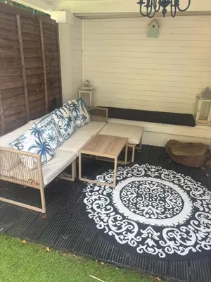 a porch with a couch and a table and a rug at Hertford detached home garden pet friendly parking in Moffat