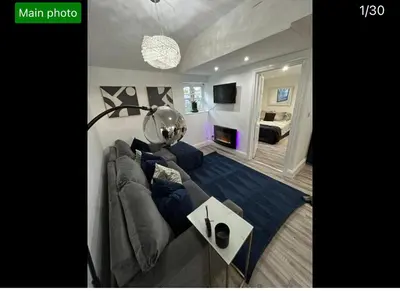 a large living room with a couch and a television at Hertford detached home garden pet friendly parking in Moffat