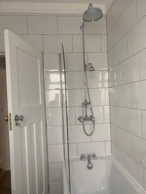 a bathroom with a shower and a bath tub at The Troon Hoose in Troon
