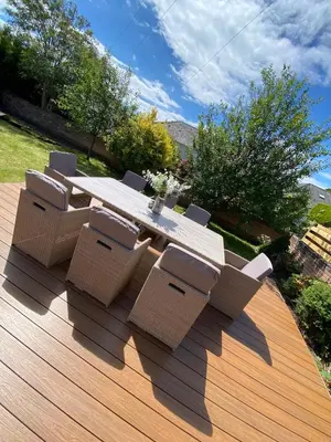 a table and chairs on a wooden deck at The Troon Hoose in Troon