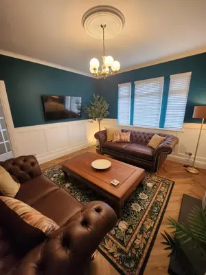 a living room with couches and a coffee table at The Troon Hoose in Troon