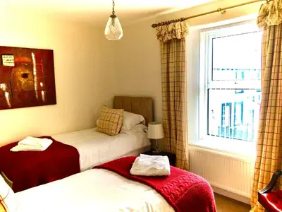 a bedroom with two beds and a window at The MireHouse - Georgian rural retreat in Ullock