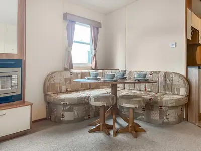 a living room with a table and a couch at Platinum in Newton Stewart