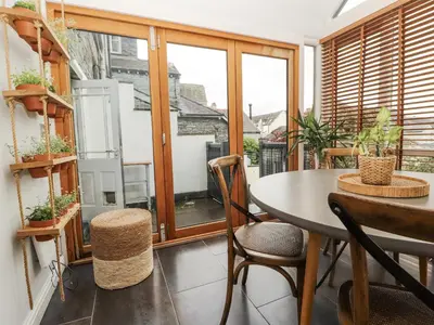 a balcony with a table and chairs and a window at 43 Station Road in Keswick