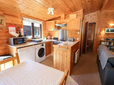 a kitchen with a washer and dryer in a cabin at Watendlath in Keswick