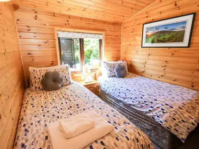 a bedroom with two beds in a log cabin at Watendlath in Keswick