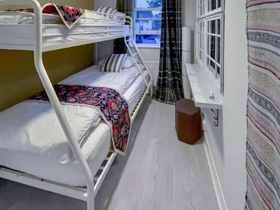 a bunk bed room with two bunk beds and a window at Rubby Banks Retreat in Cockermouth