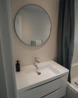a bathroom with a sink and a mirror at Anchors Retreat in Ayr