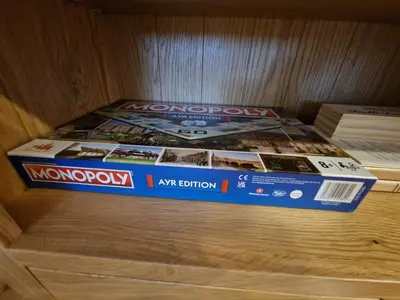 two boxes of magazines sitting on top of a wooden table at Anchors Retreat in Ayr